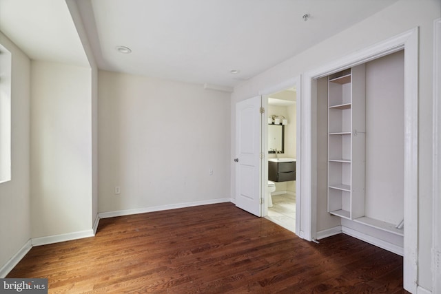 unfurnished bedroom with dark hardwood / wood-style floors