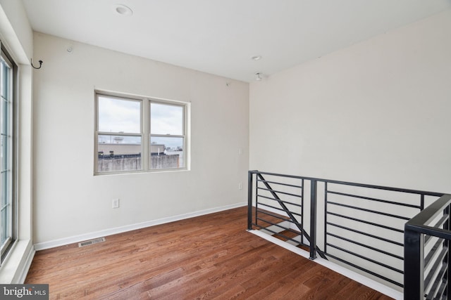 unfurnished room featuring hardwood / wood-style flooring