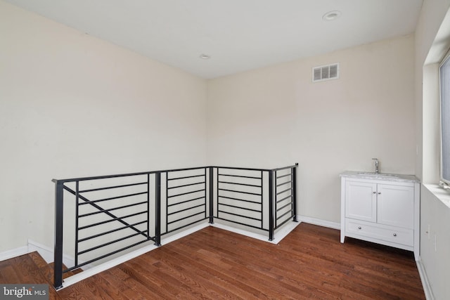 interior space with dark hardwood / wood-style floors and sink