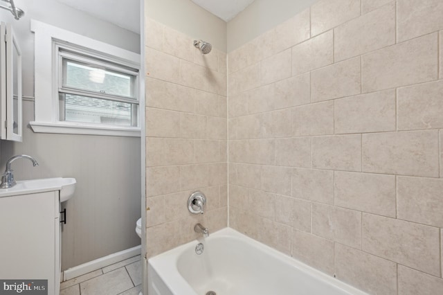 full bathroom with vanity, tile patterned floors, tiled shower / bath combo, and toilet