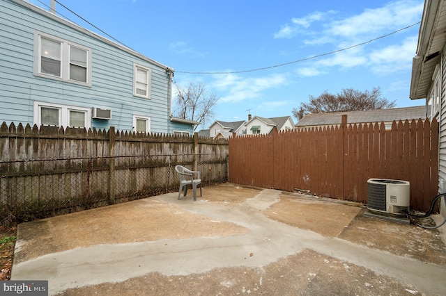 view of patio featuring cooling unit and a wall mounted AC