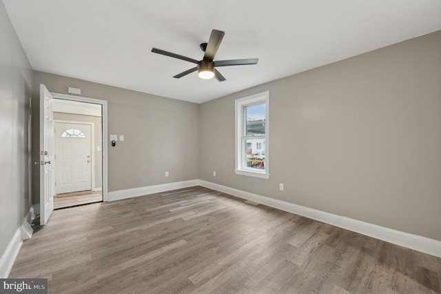 empty room featuring light wood-type flooring and ceiling fan