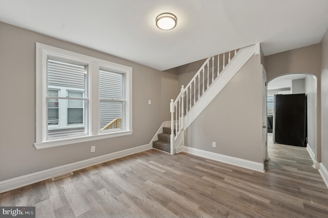 spare room featuring wood-type flooring