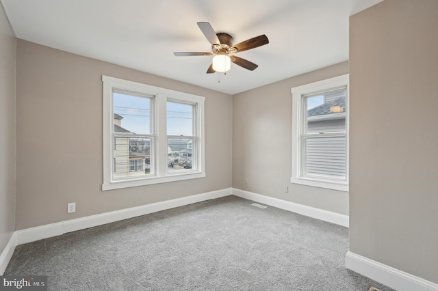 empty room featuring carpet flooring and ceiling fan