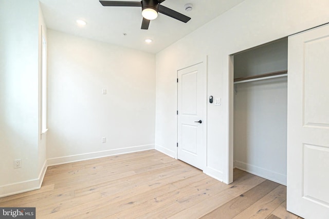 unfurnished bedroom with ceiling fan and light hardwood / wood-style floors