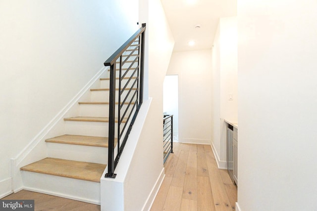 staircase featuring wood-type flooring