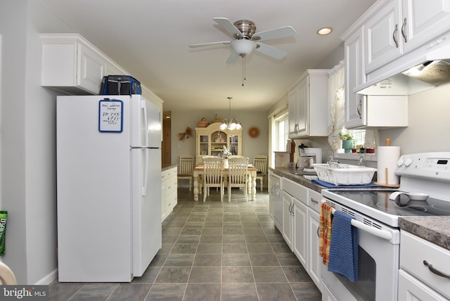 kitchen featuring custom exhaust hood, white appliances, white cabinets, ceiling fan with notable chandelier, and hanging light fixtures