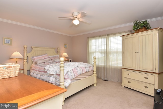 carpeted bedroom featuring ceiling fan and crown molding