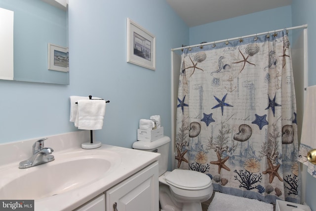 bathroom featuring vanity, toilet, and walk in shower