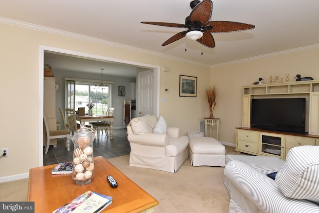 living room with ceiling fan, ornamental molding, and light carpet