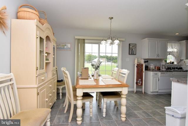 dining room featuring a chandelier and sink