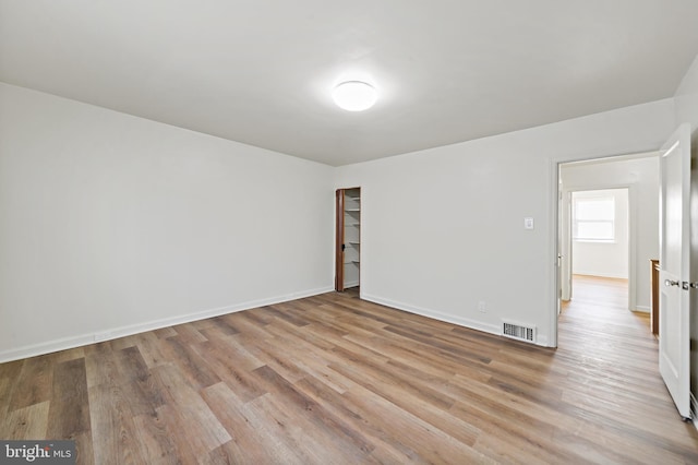 unfurnished room with light wood-type flooring