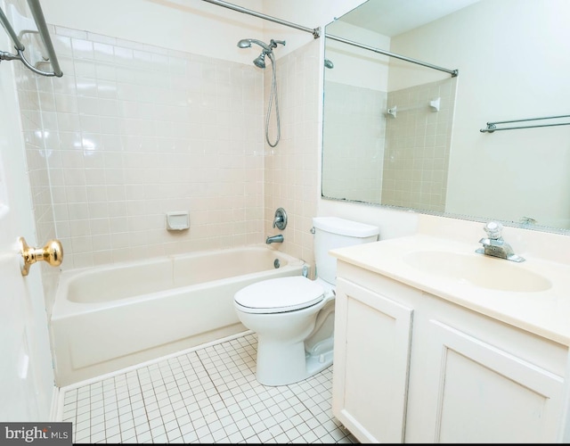 full bathroom with vanity, tiled shower / bath combo, tile patterned floors, and toilet