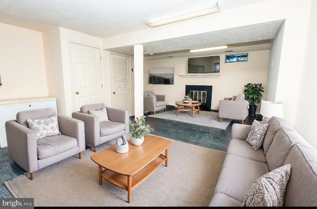 carpeted living room featuring a textured ceiling