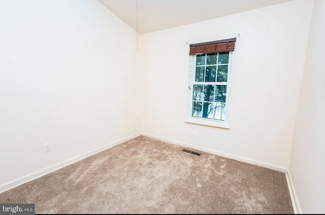 spare room with light carpet