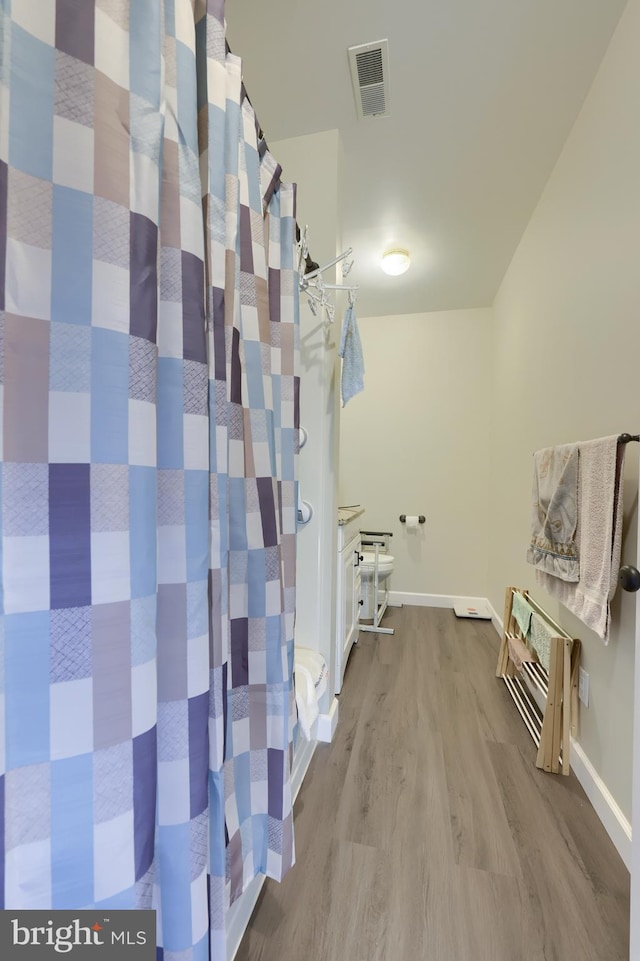 bathroom featuring hardwood / wood-style floors and heating unit