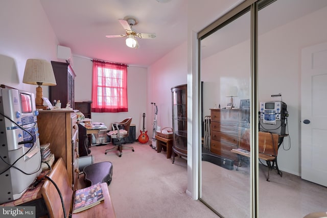 carpeted office with ceiling fan and a wall mounted AC