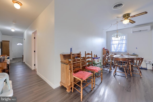 dining room featuring a wall unit AC, ceiling fan, and dark hardwood / wood-style floors