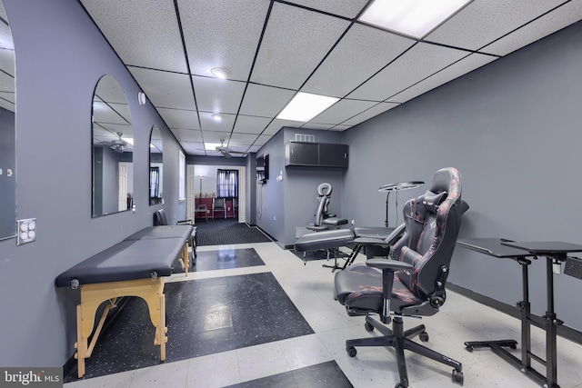 office with a paneled ceiling and ceiling fan