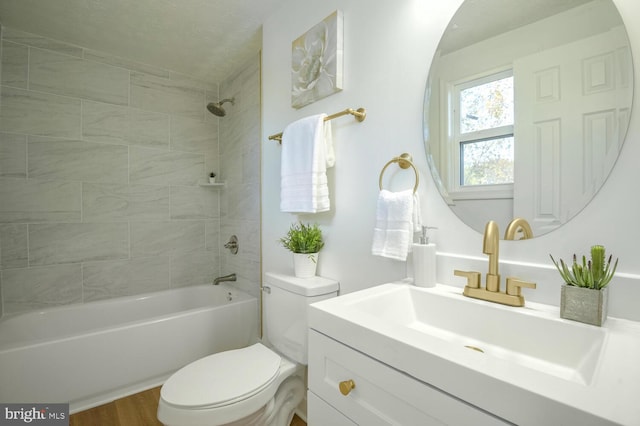 full bathroom with wood-type flooring, vanity, toilet, and tiled shower / bath