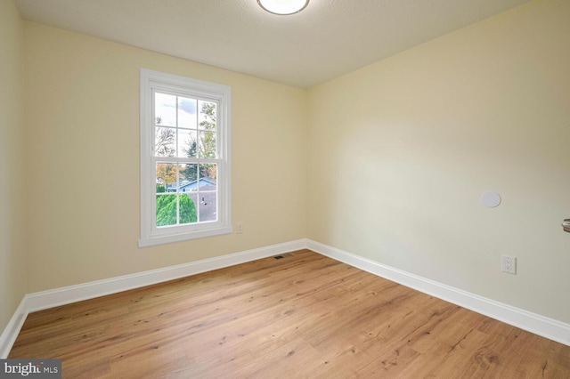 spare room featuring light hardwood / wood-style floors