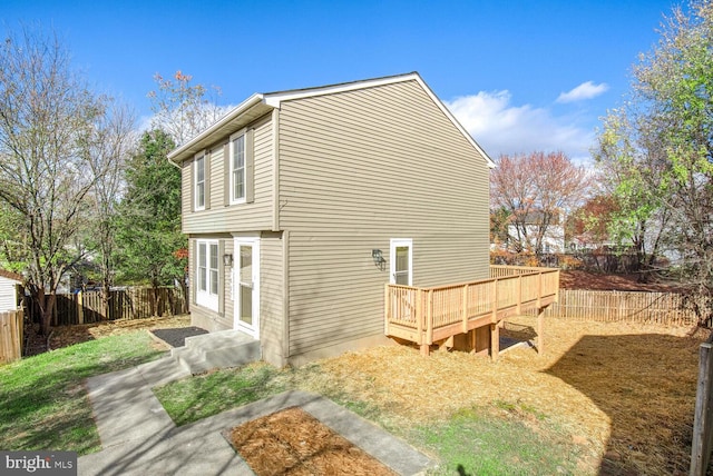 view of side of home with a wooden deck