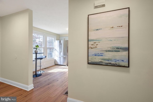 hallway with light hardwood / wood-style flooring