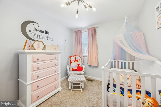 bedroom with carpet and a nursery area