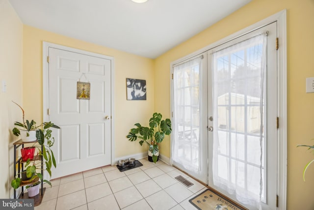 doorway featuring light tile patterned flooring and french doors