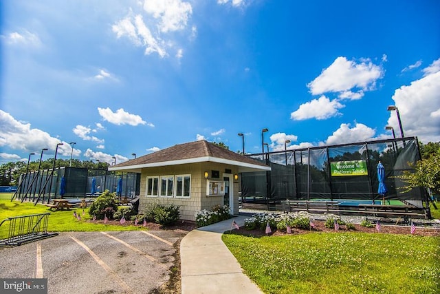 exterior space with a front lawn and a trampoline