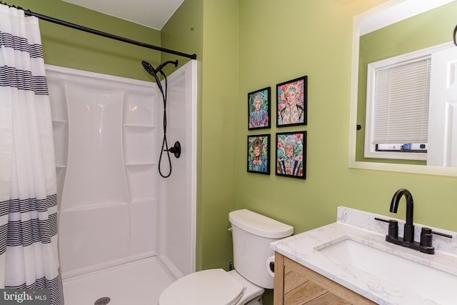 bathroom featuring vanity, toilet, and curtained shower