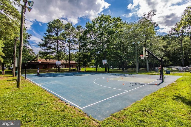 view of basketball court with a lawn