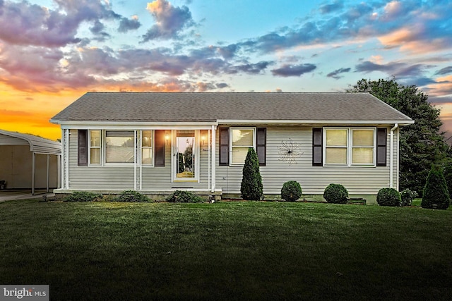 view of front of house with a yard and a carport