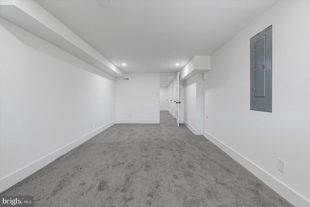 basement featuring electric panel and carpet floors