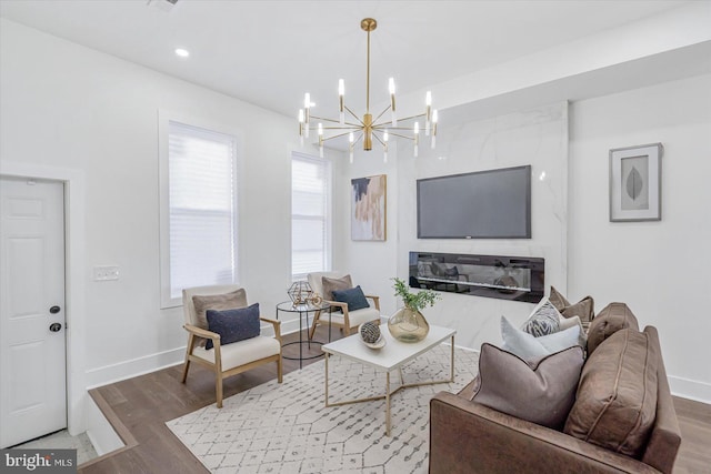 living room featuring wood-type flooring and an inviting chandelier