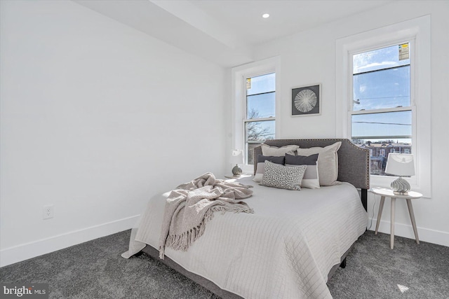 bedroom with dark colored carpet