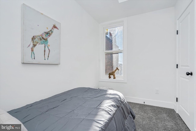 bedroom with carpet flooring and lofted ceiling