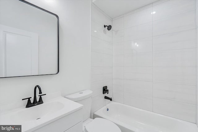 full bathroom featuring vanity, toilet, and tiled shower / bath