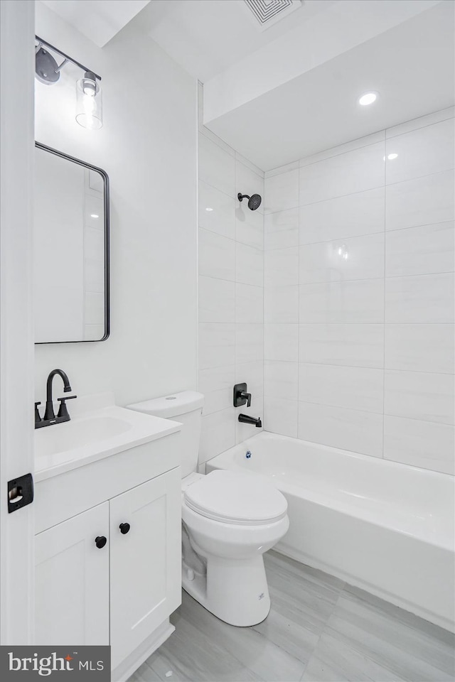 full bathroom featuring vanity, toilet, and tiled shower / bath