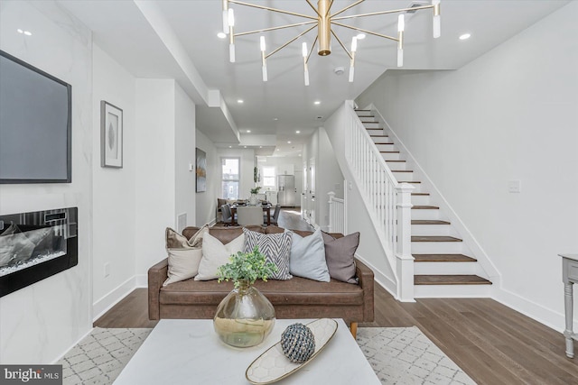 living room featuring hardwood / wood-style floors and an inviting chandelier