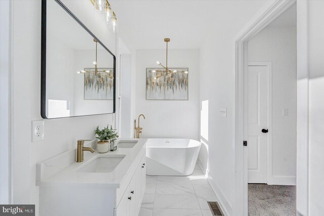 bathroom featuring a tub to relax in, vanity, and a chandelier