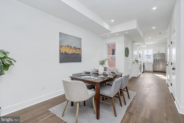 dining area featuring dark hardwood / wood-style floors and sink