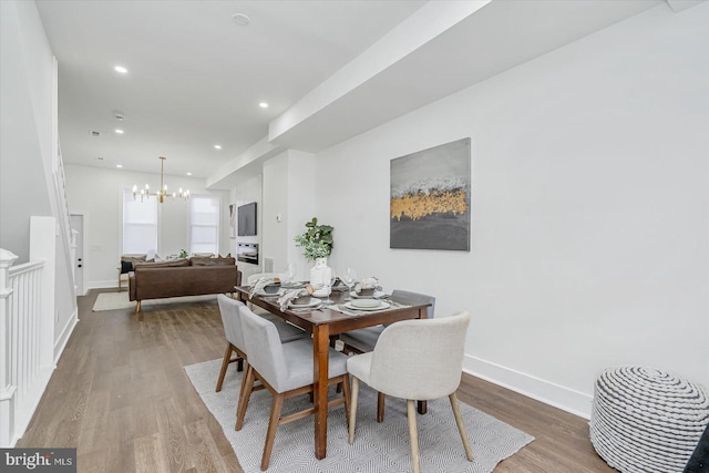 dining space with a chandelier and hardwood / wood-style flooring