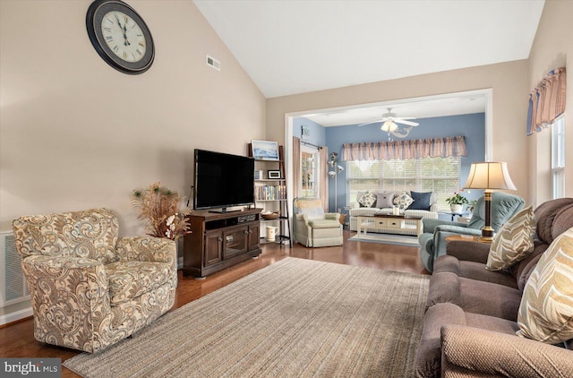 living room featuring dark hardwood / wood-style flooring, ceiling fan, and lofted ceiling