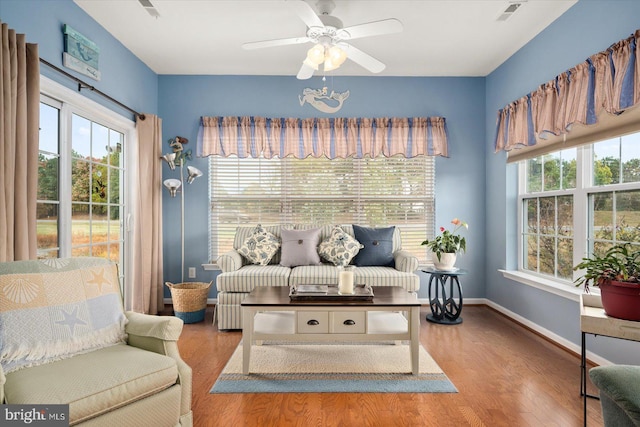 living area featuring ceiling fan and light hardwood / wood-style floors