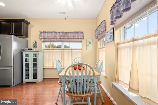 dining space with hardwood / wood-style flooring and ceiling fan