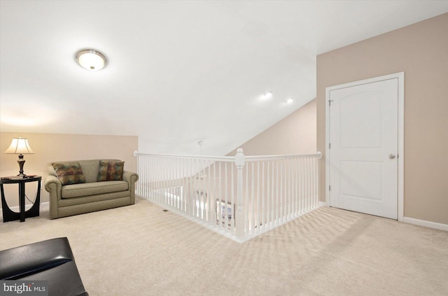 interior space with carpet and vaulted ceiling