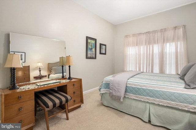 bedroom featuring light colored carpet