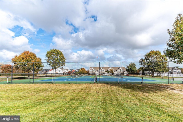 view of sport court featuring a yard