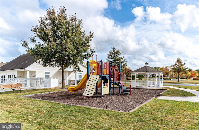 view of playground with a gazebo and a lawn